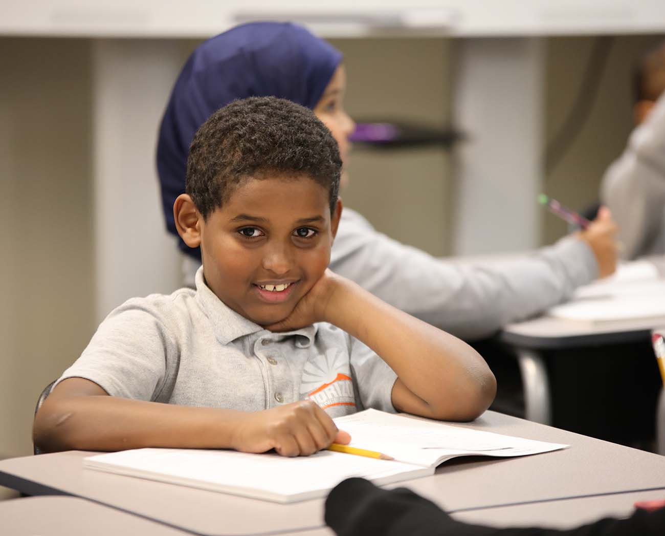Smiling children together outdoors.